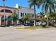 Attractive street view with palm trees, tropical plants, colorful boutiques, and modern cars parked nearby at 1886 Killdeer Ct, Venice, FL 34293
