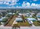 Light blue home with shed, palm trees and circular driveway situated in a quiet residential area near local businesses at 1971 Pennsylvania Ave, Englewood, FL 34224