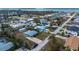 Overhead view of light blue home with shed, palm trees, and circular driveway situated in a quiet residential area at 1971 Pennsylvania Ave, Englewood, FL 34224