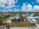 Inviting single-story home with lush landscaping, a well-kept yard, and bright, cloud-filled skies at 1971 Pennsylvania Ave, Englewood, FL 34224