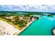 Aerial view of waterfront area featuring a beach, parking, docks, and a beautiful coastline in a vibrant coastal community at 201 Cavallini Dr, Nokomis, FL 34275