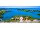 Aerial view of coastal neighborhood featuring lush islands, waterfront views, and convenient boat parking near the marina at 201 Cavallini Dr, Nokomis, FL 34275