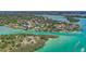 Aerial view of waterfront properties, including lush vegetation, boats and the beautiful, clear waterway at 201 Cavallini Dr, Nokomis, FL 34275