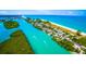 An elevated view of a river flowing into the sea, revealing the waterfront homes, lush foliage, and boat traffic at 201 Cavallini Dr, Nokomis, FL 34275