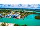 Aerial view capturing the boat storage buildings, waterfront homes, canals, and the lush landscape of the surrounding community at 201 Cavallini Dr, Nokomis, FL 34275