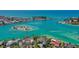 Aerial view of a waterfront community with boats, beaches and clear turquoise waters at 201 Cavallini Dr, Nokomis, FL 34275
