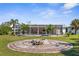 Well-kept backyard with a circular fire pit, offering plenty of space for outdoor activities and entertaining near the screened pool at 201 Cavallini Dr, Nokomis, FL 34275
