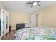 Bright bedroom with ceiling fan, wood-look floors, and closet at 201 Cavallini Dr, Nokomis, FL 34275