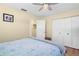Bright bedroom with hardwood floors, ceiling fan, a comfortable bed, and convenient closet space at 201 Cavallini Dr, Nokomis, FL 34275