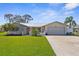 Charming single-story home featuring a metal roof, well-maintained lawn, and attached garage, complete with a paved driveway at 201 Cavallini Dr, Nokomis, FL 34275