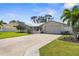 Well-maintained single-story home featuring a metal roof and manicured landscaping at 201 Cavallini Dr, Nokomis, FL 34275