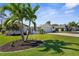 Charming single-story home with lush lawn, mature palms, and light exterior paint at 201 Cavallini Dr, Nokomis, FL 34275