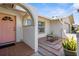 Inviting front porch with arched entry and brick flooring leading to a pink front door at 201 Cavallini Dr, Nokomis, FL 34275