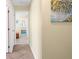 Neutral hallway leading to other rooms, featuring ceramic tile floors and a serene, inviting atmosphere at 201 Cavallini Dr, Nokomis, FL 34275