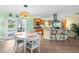 Bright dining area with a view into a spacious kitchen and outdoor pool at 201 Cavallini Dr, Nokomis, FL 34275