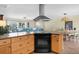 Open kitchen with granite countertops, stainless steel range hood, breakfast bar and access to the comfortable living space at 201 Cavallini Dr, Nokomis, FL 34275