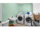 Functional laundry room featuring a sink, washer, and dryer at 201 Cavallini Dr, Nokomis, FL 34275