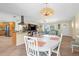 Open-concept living room and dining area featuring tile floors, stylish decor, and plenty of natural light at 201 Cavallini Dr, Nokomis, FL 34275