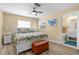 Bright main bedroom featuring a ceiling fan, wood-look floors, and a bathroom ensuite at 201 Cavallini Dr, Nokomis, FL 34275