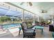 Screened-in patio featuring ample seating and pool at 201 Cavallini Dr, Nokomis, FL 34275