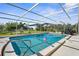 Enclosed pool area with lounge chairs and a clear view of the backyard, offering an ideal outdoor living space at 201 Cavallini Dr, Nokomis, FL 34275