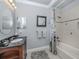 Bathroom featuring a wood vanity, patterned shower curtain, and a framed horse photo at 206 Bella Vista Ter # 29A, Nokomis, FL 34275