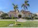 Stunning Mediterranean-style building with lush landscaping, palm trees, and a brick walkway at 206 Bella Vista Ter # 29A, Nokomis, FL 34275