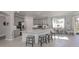 A stylish kitchen features gray cabinets, a marble island with seating, and stainless steel appliances at 206 Bella Vista Ter # 29A, Nokomis, FL 34275