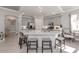 A modern kitchen featuring gray cabinets, stainless steel appliances, and a marble island with seating at 206 Bella Vista Ter # 29A, Nokomis, FL 34275