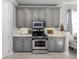 Gray cabinets line the kitchen, complemented by stainless steel appliances and marble countertops at 206 Bella Vista Ter # 29A, Nokomis, FL 34275