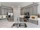 A well-appointed kitchen features gray cabinets, a large island, and stainless steel appliances at 206 Bella Vista Ter # 29A, Nokomis, FL 34275