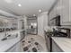 A spacious kitchen with gray cabinets, stainless steel appliances, and marble countertops at 206 Bella Vista Ter # 29A, Nokomis, FL 34275