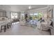 Bright and airy living room with tile floors, neutral decor, and large windows with serene views at 206 Bella Vista Ter # 29A, Nokomis, FL 34275