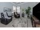Living room with leather recliners, decorative rug, and large tv with custom wood cabinet at 206 Bella Vista Ter # 29A, Nokomis, FL 34275