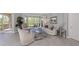 Beautiful living room showcasing stylish decor, tile flooring, and sliders to lanai at 206 Bella Vista Ter # 29A, Nokomis, FL 34275
