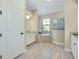 Bright bathroom featuring a soaking tub, tiled floor, double sinks and neutral color palette at 20794 Valprato Ct, Venice, FL 34293