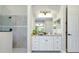 Bright bathroom featuring a shower with glass door, tiled floor, and vanity with granite top at 20794 Valprato Ct, Venice, FL 34293