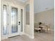 Elegant foyer with a decorative glass front door, tile flooring, and views of the dining area at 20794 Valprato Ct, Venice, FL 34293