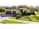 Stunning home featuring a tile roof, two-car garage, manicured lawn, and lush landscaping at 20794 Valprato Ct, Venice, FL 34293