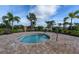 A relaxing hot tub area within the community featuring comfortable seating and lush landscaping for a tranquil spa experience at 20794 Valprato Ct, Venice, FL 34293