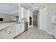 Bright kitchen featuring stainless appliances, granite countertops, and white cabinetry at 20794 Valprato Ct, Venice, FL 34293