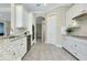 Bright kitchen featuring stainless appliances, granite countertops, and white cabinetry at 20794 Valprato Ct, Venice, FL 34293