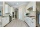 Bright kitchen featuring stainless appliances, granite countertops, and white cabinetry at 20794 Valprato Ct, Venice, FL 34293