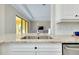 Bright kitchen featuring stainless appliances, granite countertops, and white cabinetry at 20794 Valprato Ct, Venice, FL 34293
