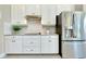 Bright kitchen featuring stainless appliances, granite countertops, and white cabinetry at 20794 Valprato Ct, Venice, FL 34293