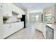 Bright kitchen featuring stainless appliances, granite countertops, and white cabinetry at 20794 Valprato Ct, Venice, FL 34293