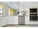 Bright kitchen featuring stainless appliances, granite countertops, and white cabinetry at 20794 Valprato Ct, Venice, FL 34293