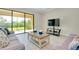 The bright living room features light tile floors, neutral paint, and a sliding glass door at 20794 Valprato Ct, Venice, FL 34293