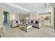 Open-concept living room and kitchen area with tile flooring and neutral colors at 20794 Valprato Ct, Venice, FL 34293