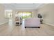 Bright living room with tile flooring, large windows, and open layout connecting to the kitchen at 20794 Valprato Ct, Venice, FL 34293